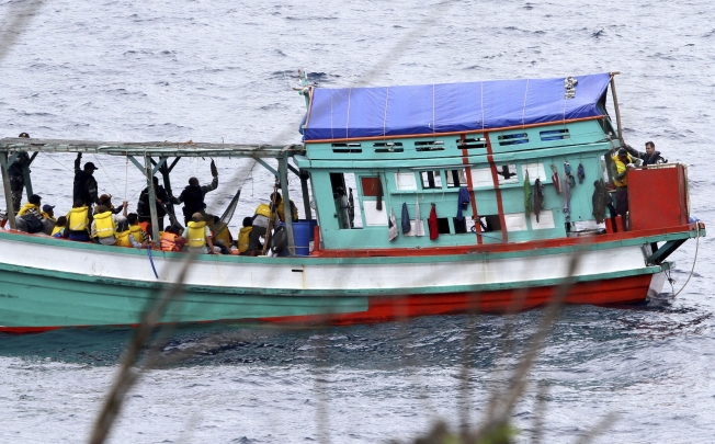 A fishing boat carrying Vietnamese asylum seekers nears the shore of Australia's Christmas Island in April 2013. Photo: AP