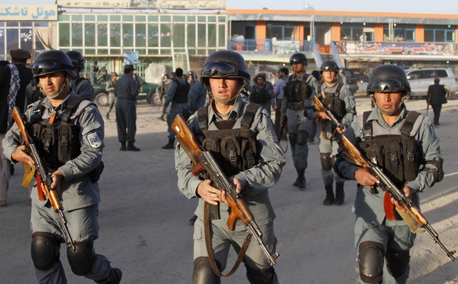 Afghan policemen move around near Kabul airport, Afghanistan. Photo: AP