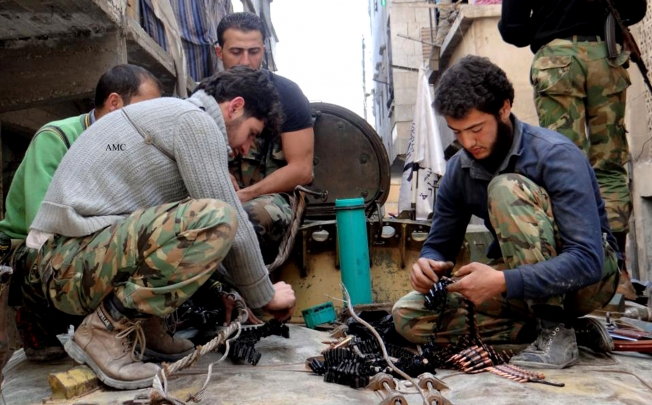 Members of the free Syrian Army preparing their weapons, in the neighborhood of al-Amerieh in Aleppo, Syria. Photo: AP