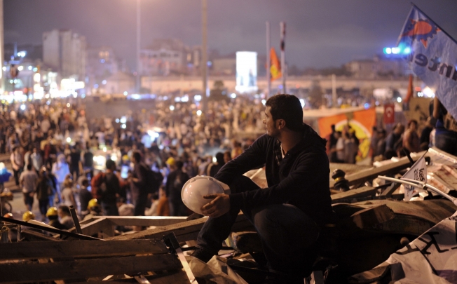 An anti-government protester looks to Taksim Square at Gezi Park in Istanbul. Photo: AFP