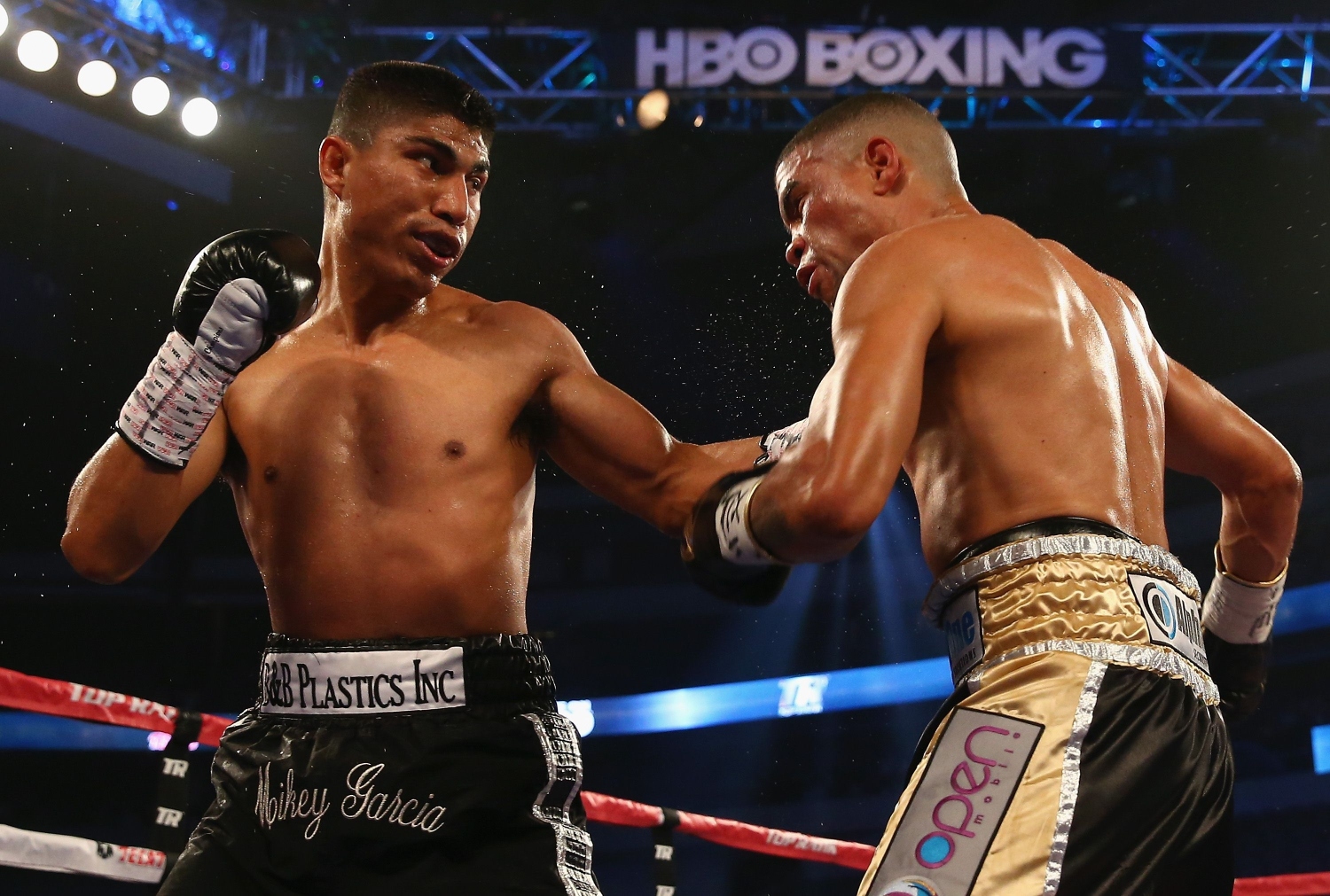 Mikey Garcia connects with a left to the face of Juan Manuel Lopez during their Vacant WBO Featherweight Title bout at American Airlines Center in Dallas, Texas. Garcia knocked out Lopez in the fourth round. Photo: AFP