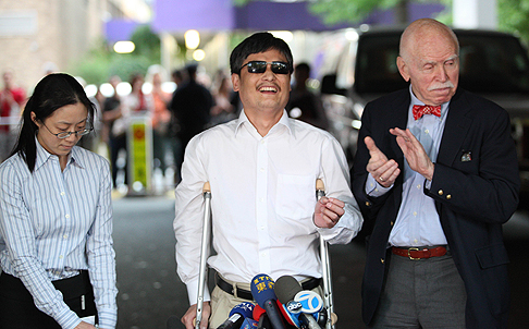 Chen Guangcheng, with NYU professor Jemore Cohen (right), arrives at NYU in May 2012. Photo: AFP