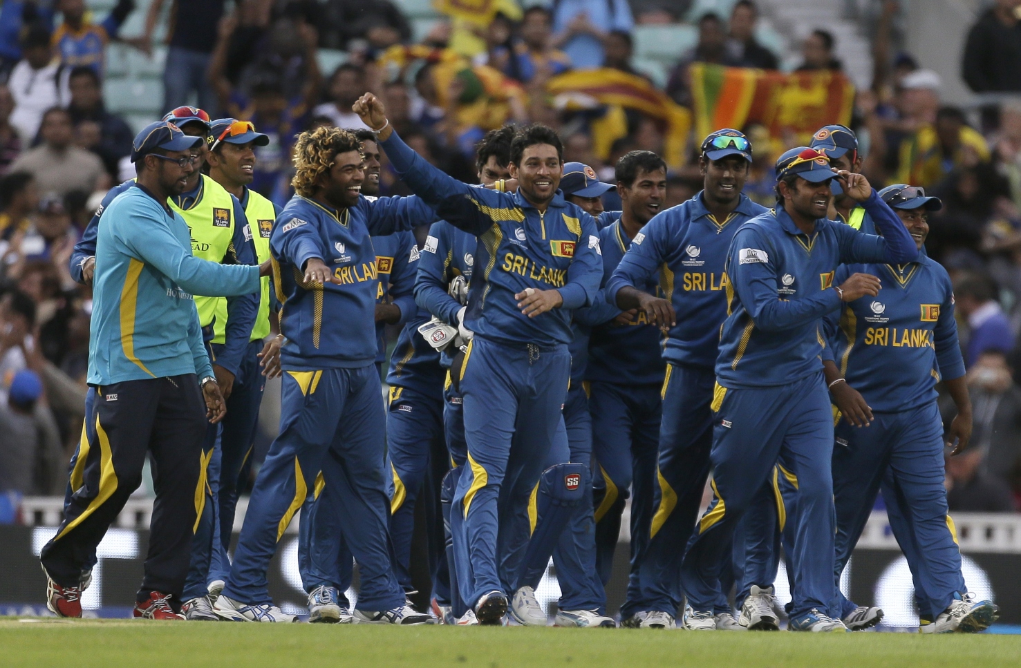 Sri Lanka's Tilakaratne Dilshan (centre) celebrates with teammates after taking the wicket of Australia's Clint McKay caught and bowled to win their ICC Champions Trophy cricket match at the Oval cricket ground in London, on Monday. Photo: AP