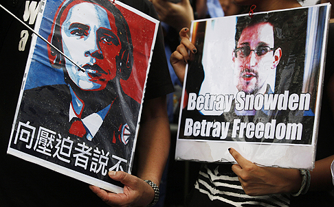 Supporters hold pictures of US President Barack Obama and Edward Snowden at a Hong Kong protest. Photo: AP