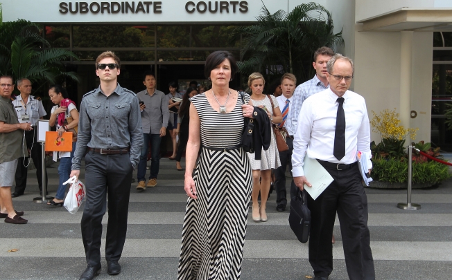 The parents of Shane Todd, Mary, front left, and Rick Todd, right, leave the Subordinate Courts of Singapore. Photo: AP