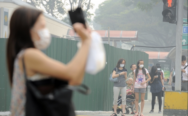 People wear masks in the street in Singapore. Photo: Xinhua