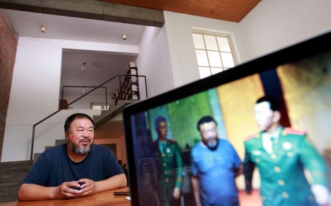 Ai Weiwei talks about his music album at his studio, as a computer screen shows one of Ai's recent dioramas about his detention. The album is dark, he says, but he's writing love songs now. Photo: Simon Song