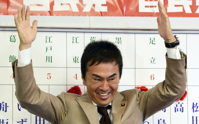 Japan's Liberal Democratic Party's senior lawmaker Nobuteru Ishihara reacts to updates of exit poll in a Tokyo assembly election. Photo: AP
