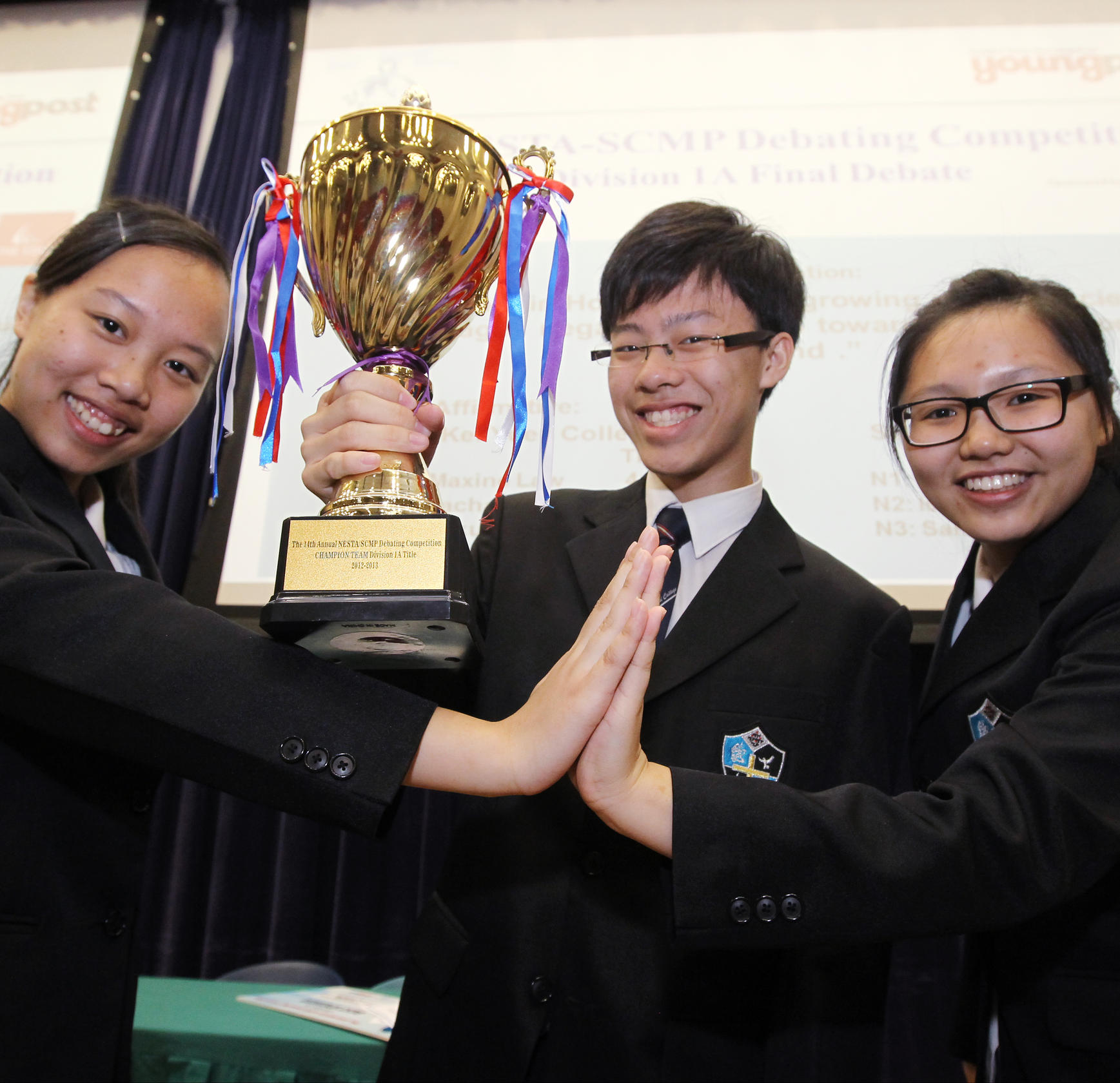 Sarah Tse, Isaac Sham and Natalie Cheung, from Stewards Pooi Kei College in Sha Tin, celebrate their win. Photo: Edward Wong