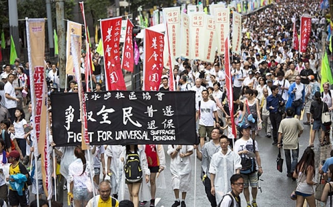 Hundreds of thousands of protesters joined the annual July 1 rally from Victoria Park to Central. Photo: EPA