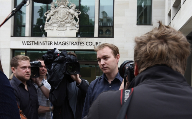 Tom Hayes, pictured here surrounded by media after a June court appearance, is the first suspect to come to court. Photo: AP