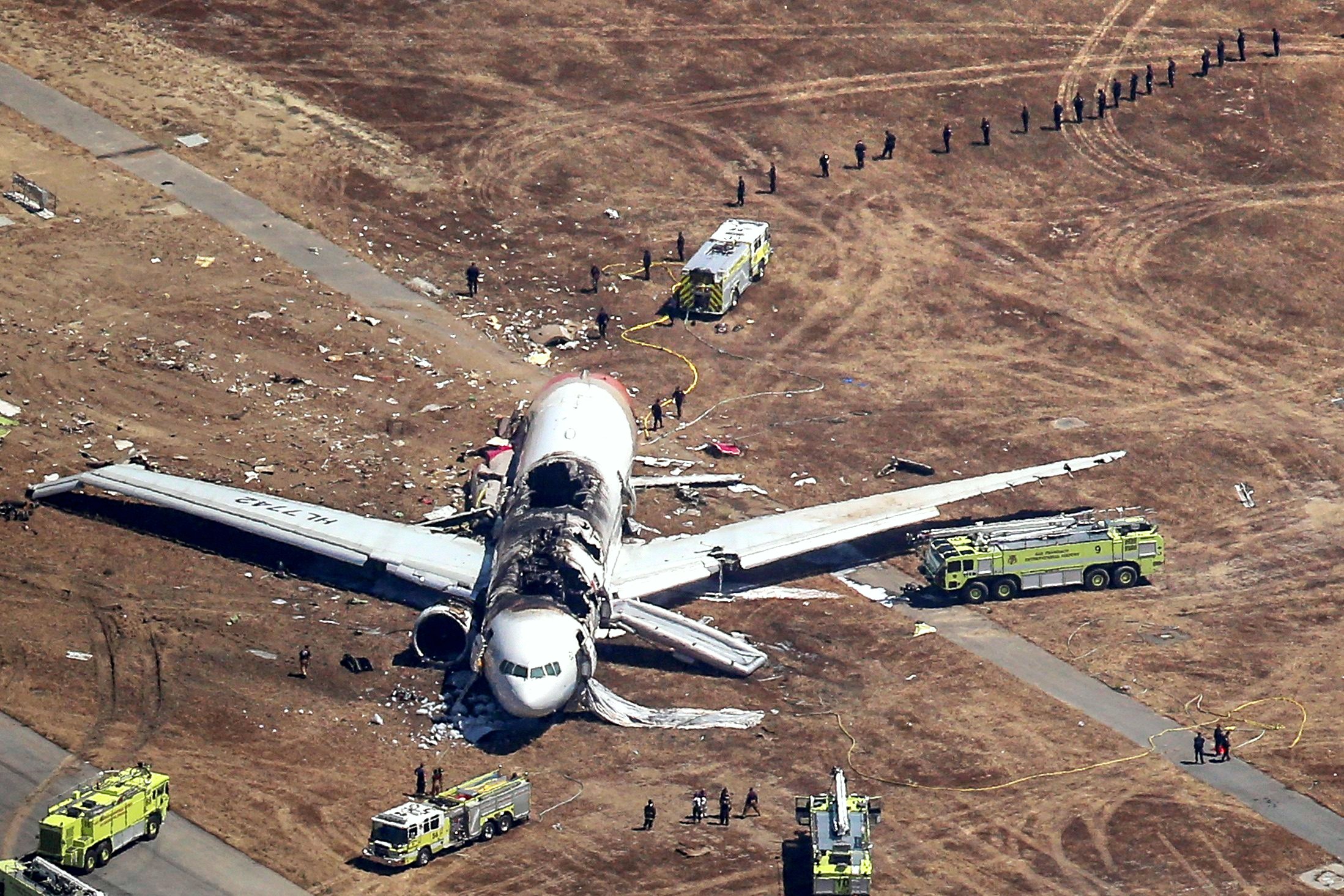 Rescue workers surround the plane on Saturday. Asiana Airlines said mechanical failure did not appear to have been a factor. Photo: Reuters