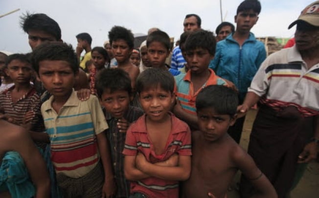 Rohingya children standing in front of a refugee camp outside of Sittwe in Myanmar. Photo: Reuters