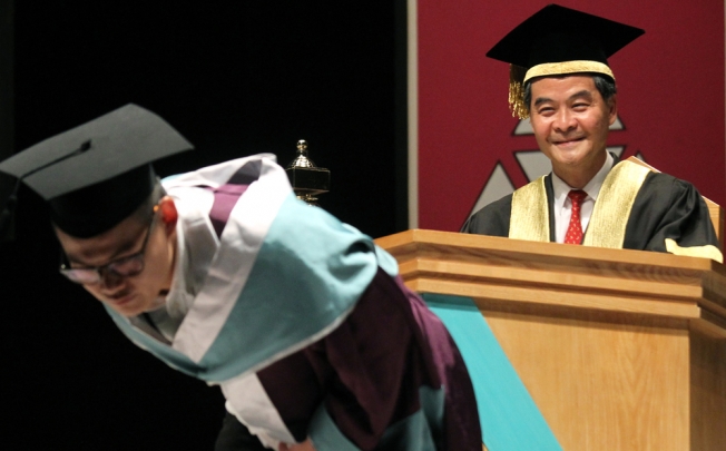 One student pulled up the back of his graduation gown, showing his butt towards the chief executive Leung Chun-ying during this year's graduation ceremony of the Hong Kong Academy for Performing Arts. Photo: SCMP
