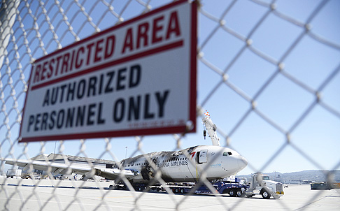 The wreckage of the Asiana Airlines Flight 214 is moved to a secure area away from the runway at San Francisco International Airport in California. Photo: EPA 