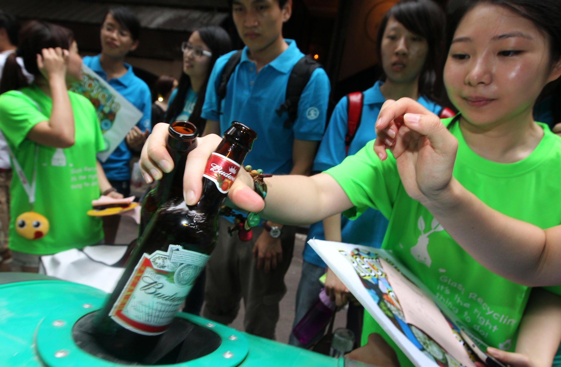 Volunteers from 2Gather and Eco Action collect glass bottles for recycling at the LKF Beer and Music Festival. Photo: Felix Wong