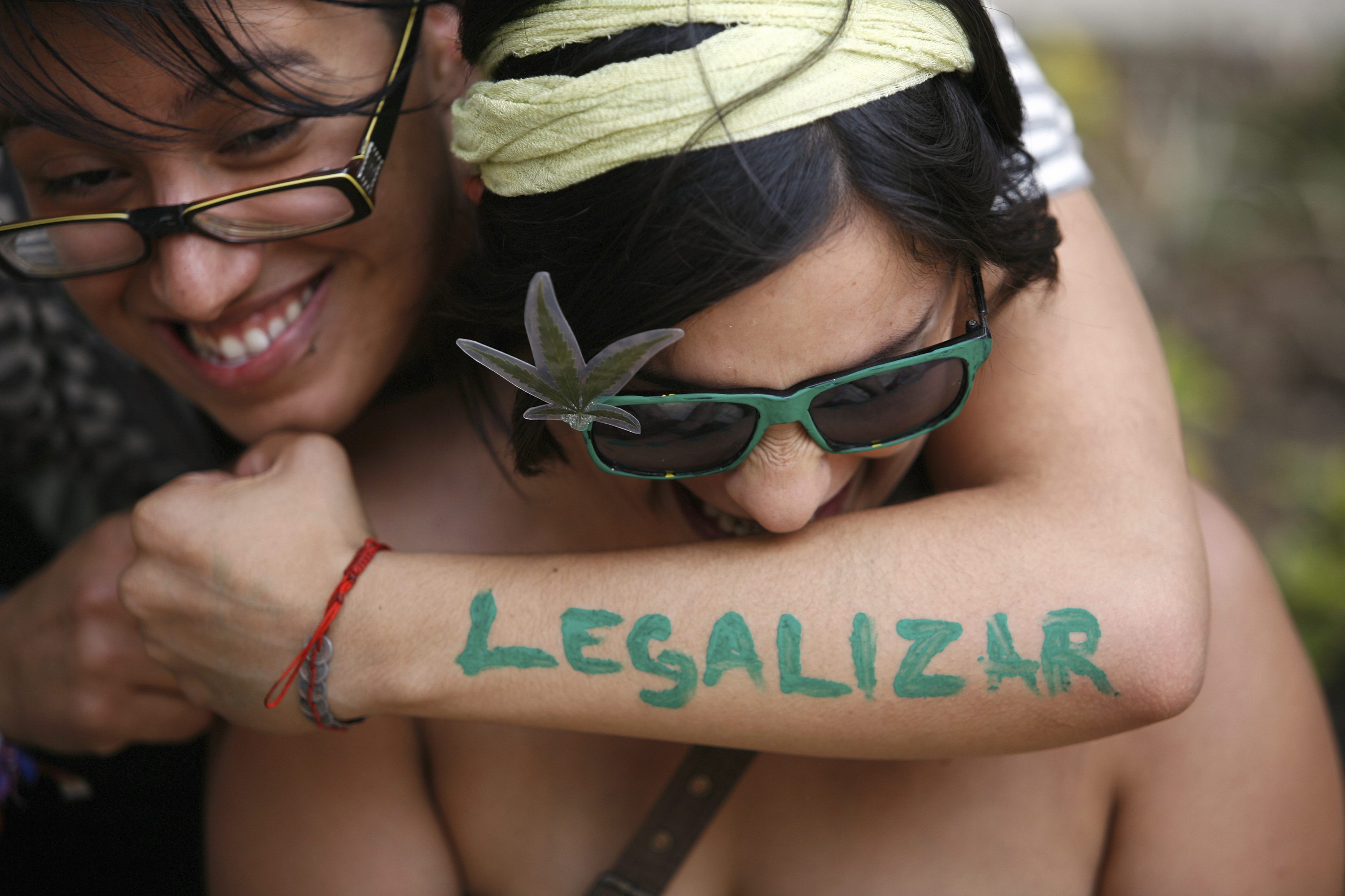 A woman embraces her friend during a rally to demand the legalization of marijuana in Mexico City. Photo: Reuters