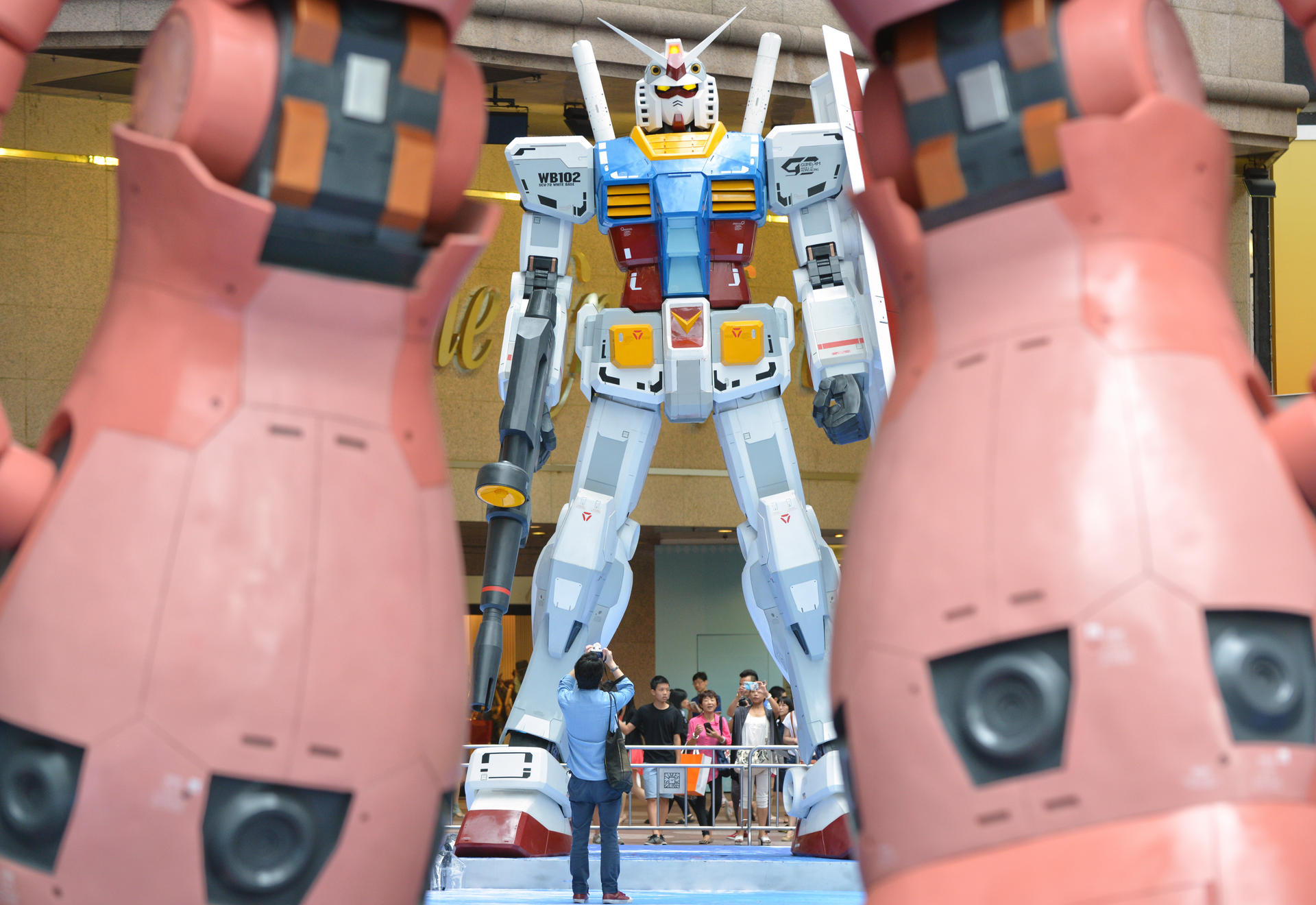 Mock-ups of giant anime robots at Times Square tower over visitors in a display that will last for more than two months. Photo: Thomas Yau