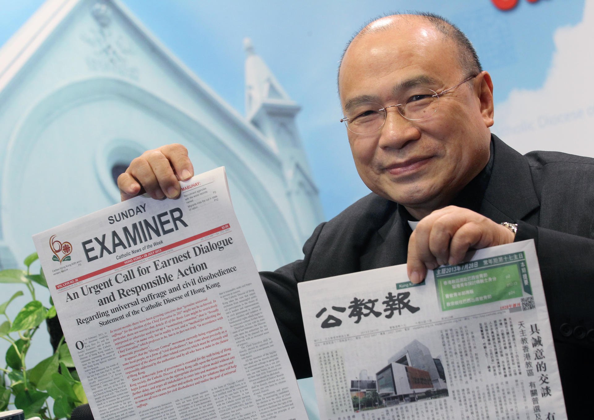 Vicar-General Michael Yeung holds up the diocese's newspaper. Photo: Dickson Lee