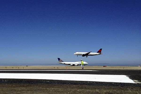 New markings are painted on the runway where an Asiana Airlines jet crash landed at San Francisco airport. Photo: EPA