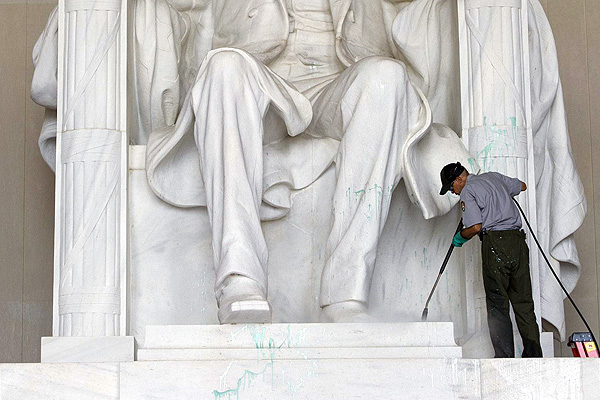 A National Park Service worker cleans paint off the Lincoln Memorial. Photo: AFP