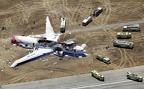 Rescue vehicles surround the wreckage of Asiana Flight 214 at San Francisco International Airport. Photo: AP 