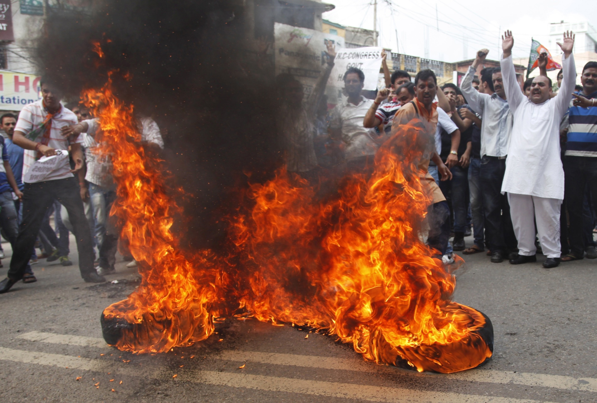 Indian Hindu protesters burn tires and shout slogans against the state government after rival communities clashed in Kishtwar. Indian forces enforce curfew in town in Kashmir. Photo: AP