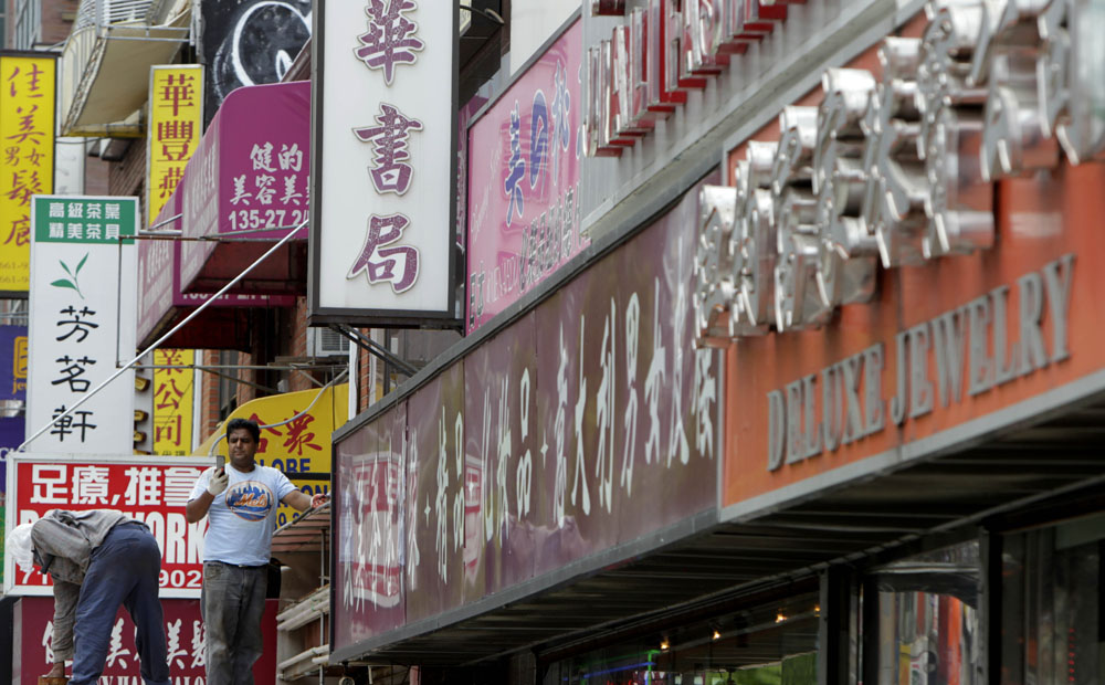 Store signs in the Flushing neighbourhood of New York. Photo: AP