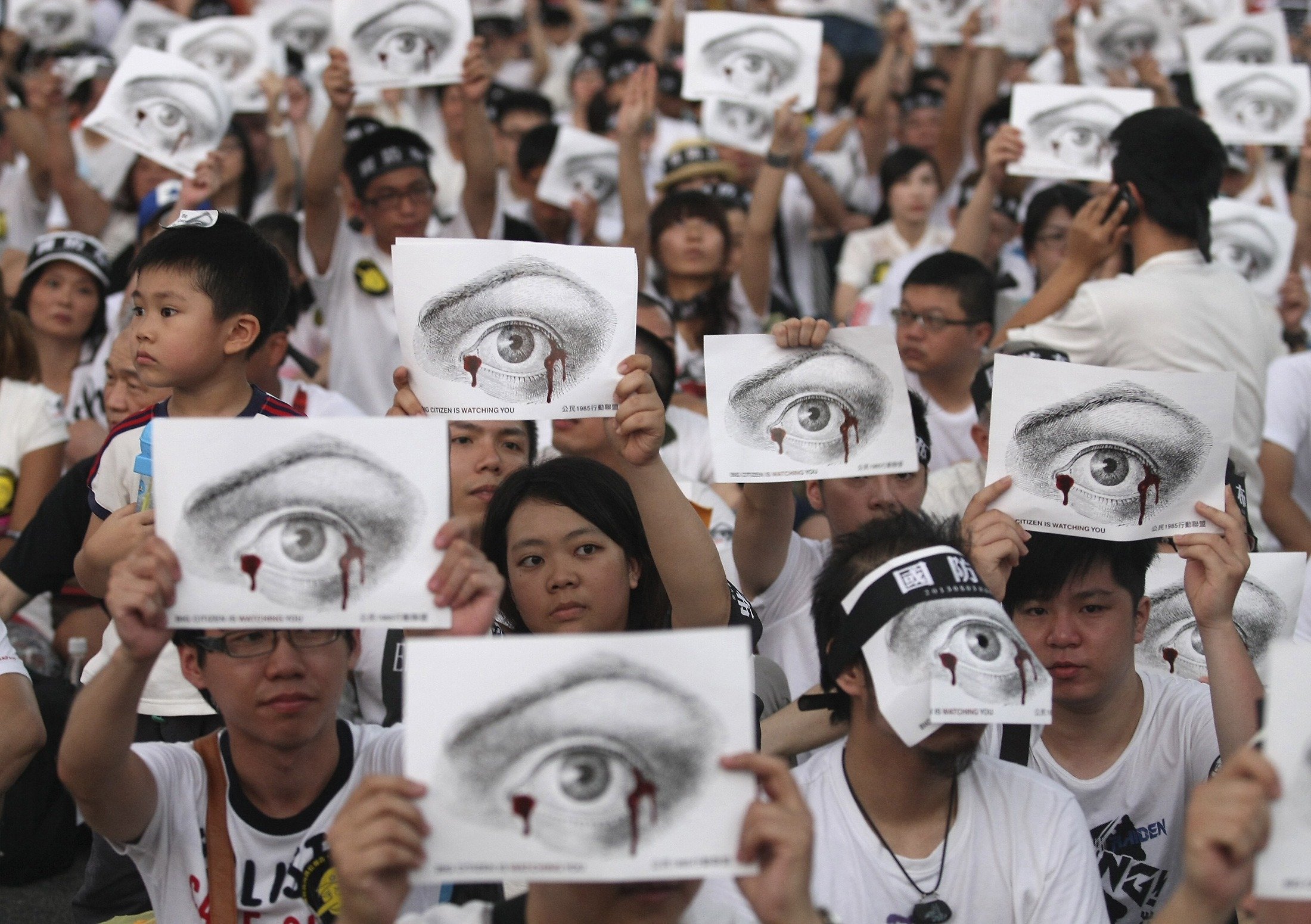 People, holding placards of a bleeding eye, take part in a demonstration in front of the Presidential Office in Taipei. Taiwan’s army chief is seeking to quit after the death of a young soldier. Photo: Reuters 