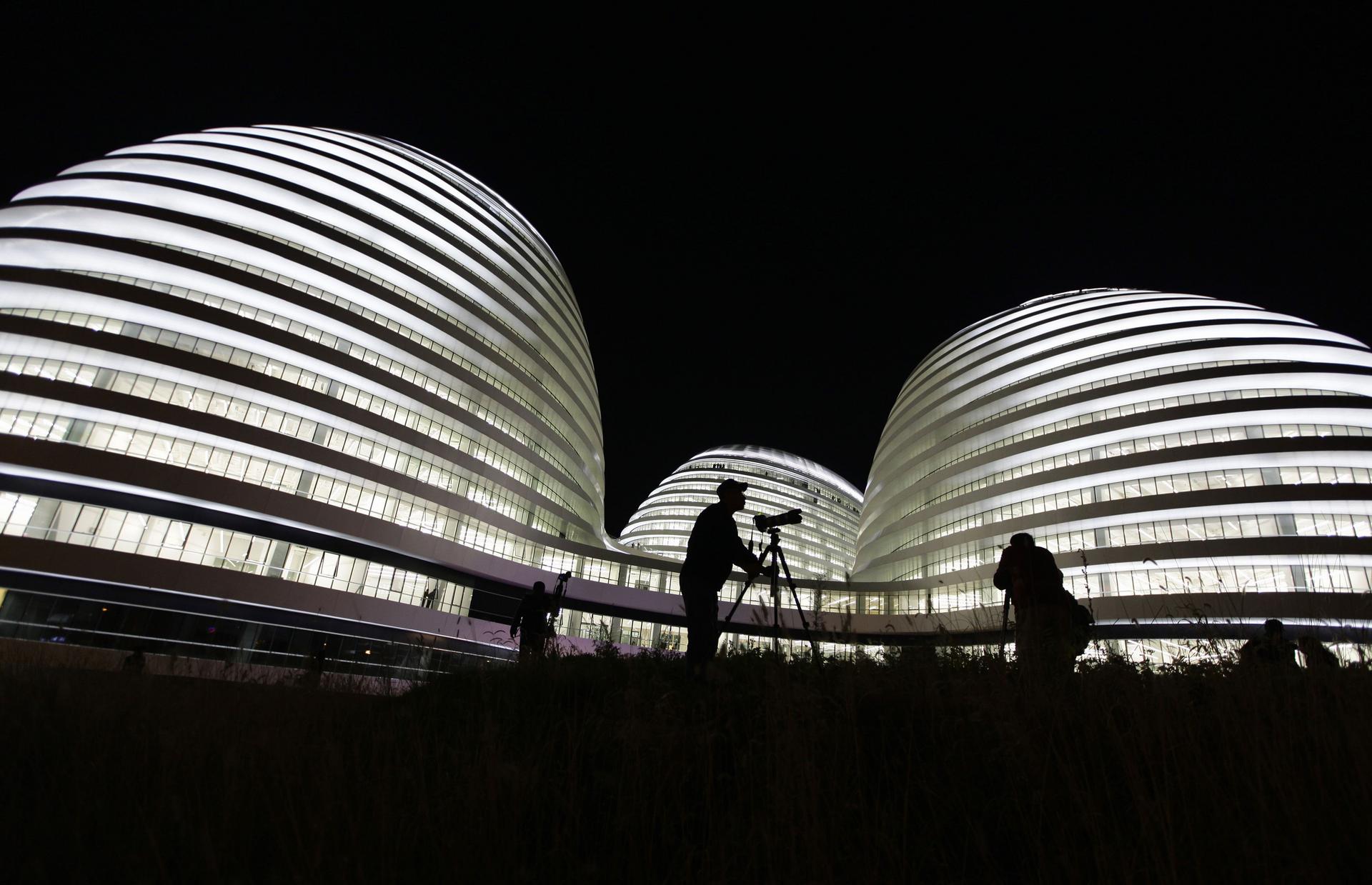 A visitor photographs the new Galaxy Soho building. Critics say the building is out of context in old Beijing. Photo: Reuters