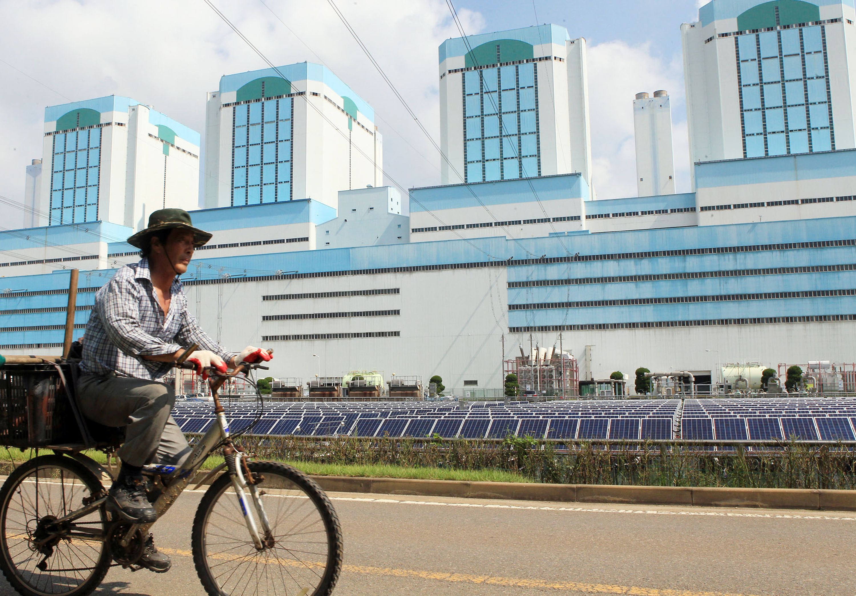 A man rides a bicycle near the Dangjin III thermal power plant. Photo: AFP