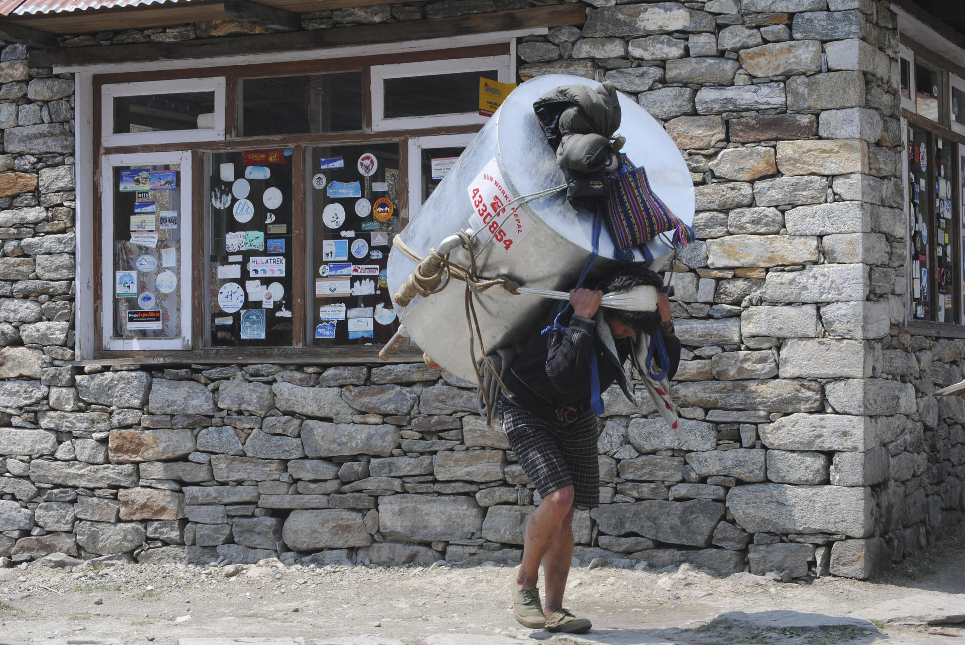 A strong back is a man's greatest asset in the remote valleys of Nepal.