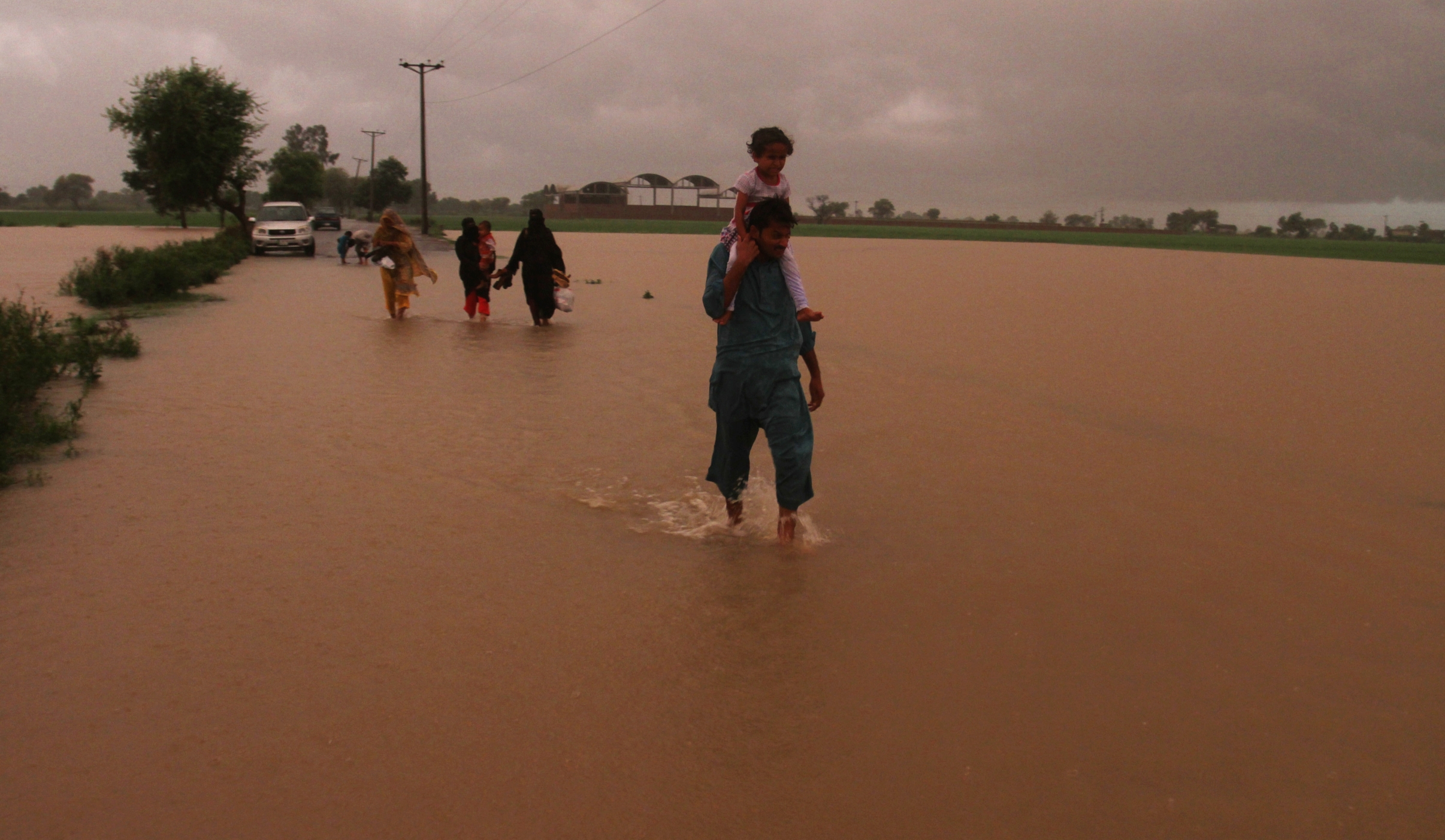 Stranded Pakistani villagers flee their flooded homes in Muridke near Lahore. Photo: AP
