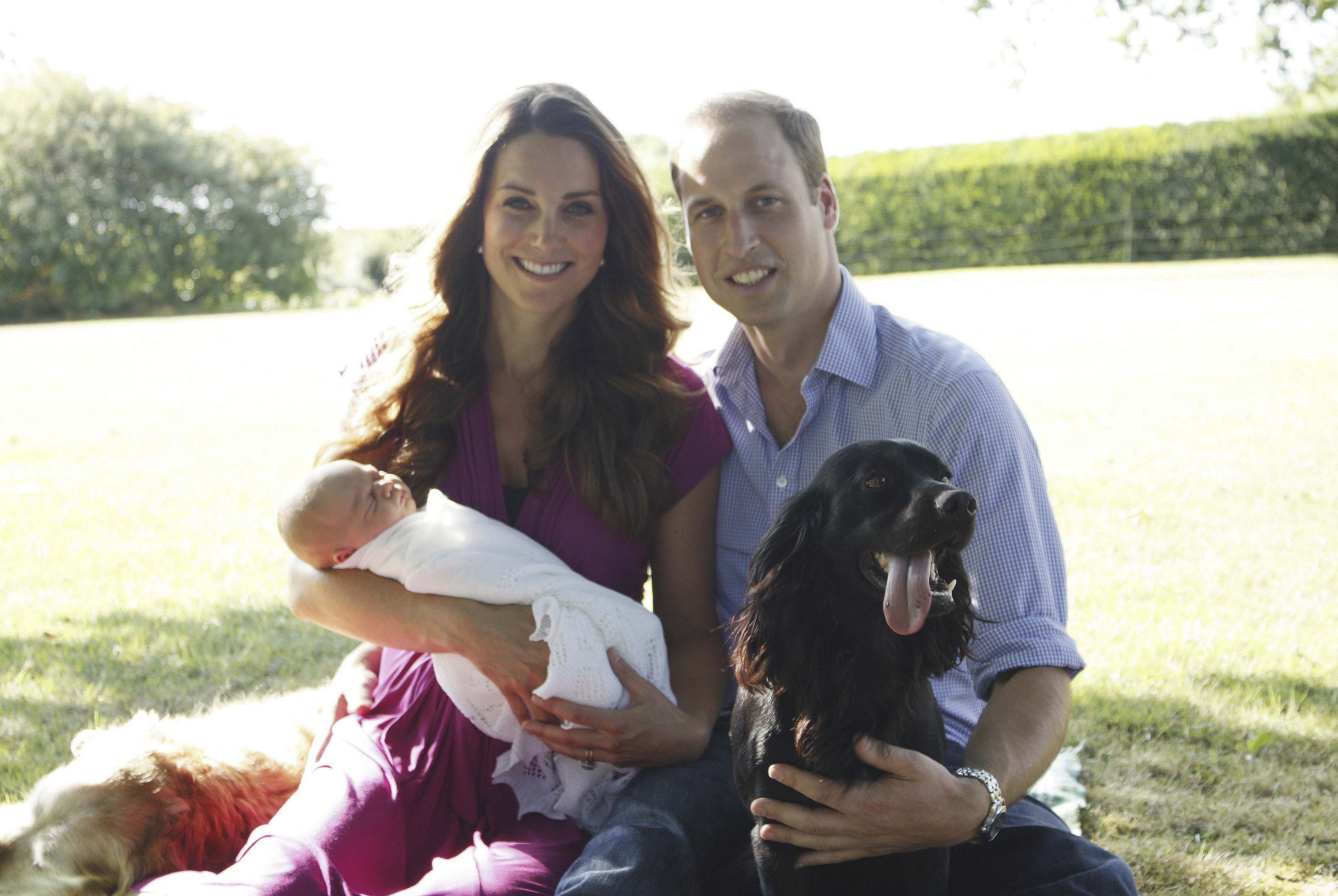 Britain's Prince William and his wife Catherine, Duchess of Cambridge, pose with their son Prince George in the garden of the Middleton family home in Bucklebury, southern England. Photo: Reuters