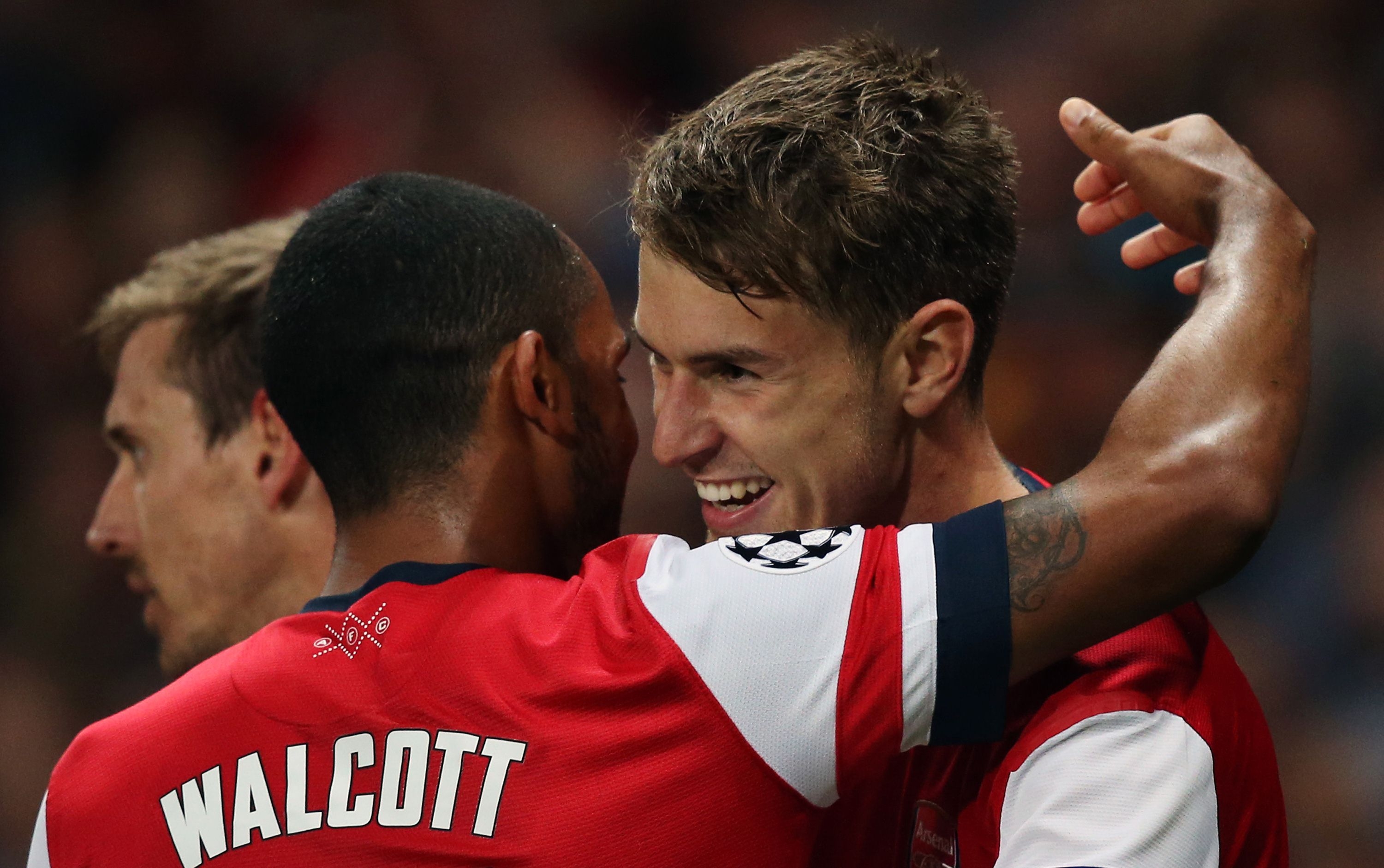 Arsenal's English midfielder Theo Walcott (left) celebrates with Arsenal's Welsh midfielder Aaron Ramsey (right) during the Uefa Champions League Play-Off football match in north London on Tuesday. Photo: AFP