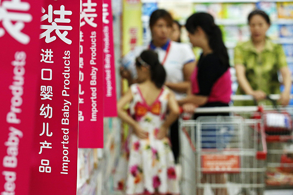 Customers shop for milk powder at a supermarket in Beijing. Photo: Reuters