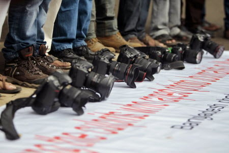 Protesters placed their cameras on a banner to condemn the recent gang rape of a photojournalist in Mumbai. Photo: AP