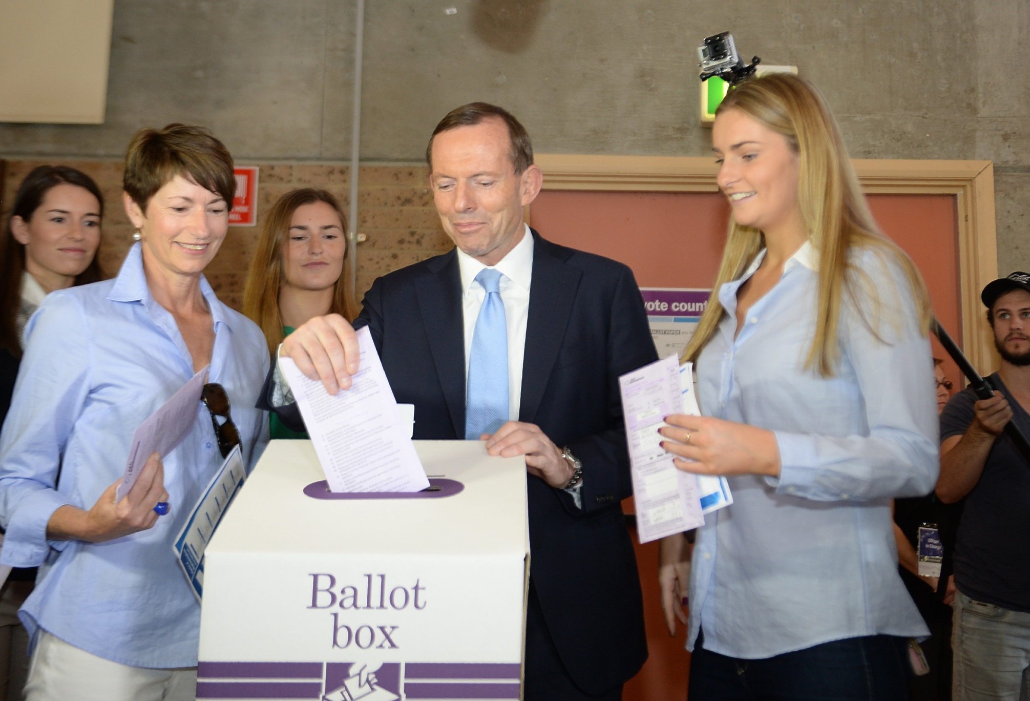 Australian Opposition Leader Tony Abbott (centre) votes at Freshwater in Sydney, Australia. Photo: EPA