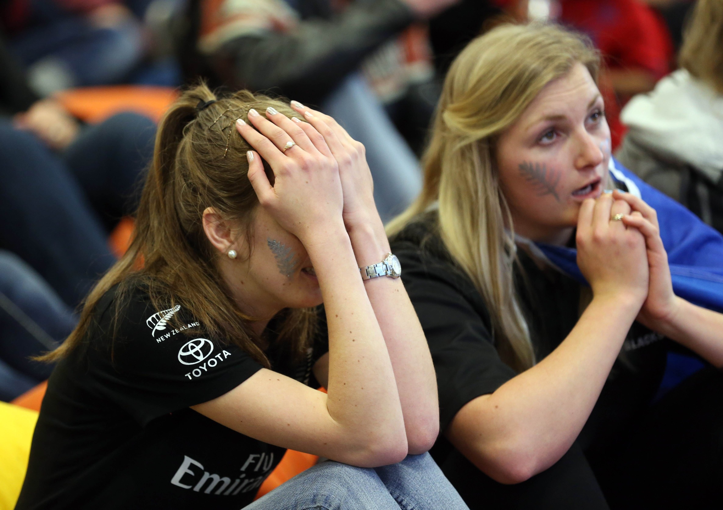Devastated fans of Team New Zealand react as they watch racing in the America's Cup in Auckland. Photo: AFP 
