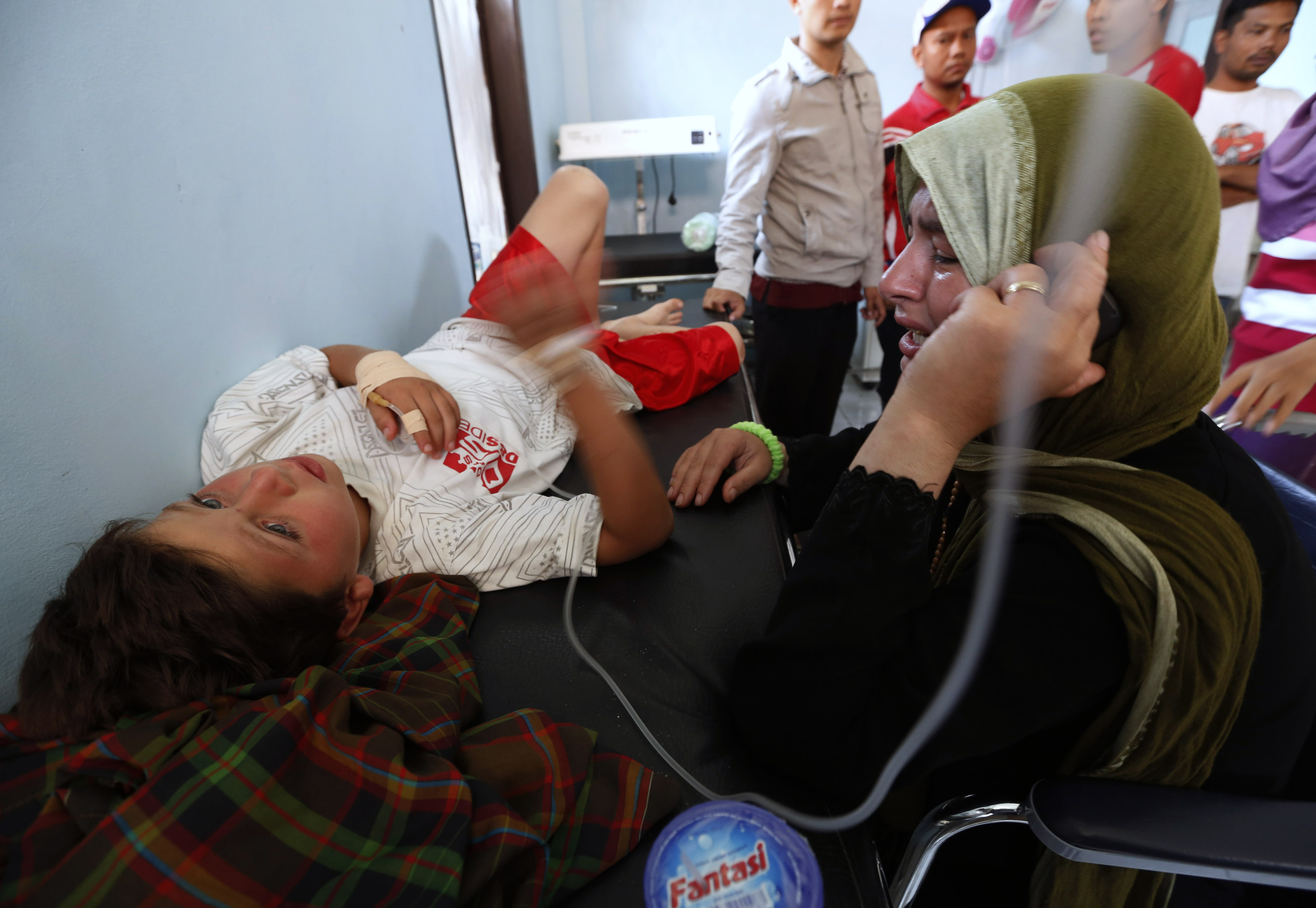 Nadine Bakour, a Lebanese woman who lost her husband and two sons in the boat sinking, cries next to her son Khalil el Rahi at Agrabinta health clinic in Indonesia's West Java province. Photo: Reuters