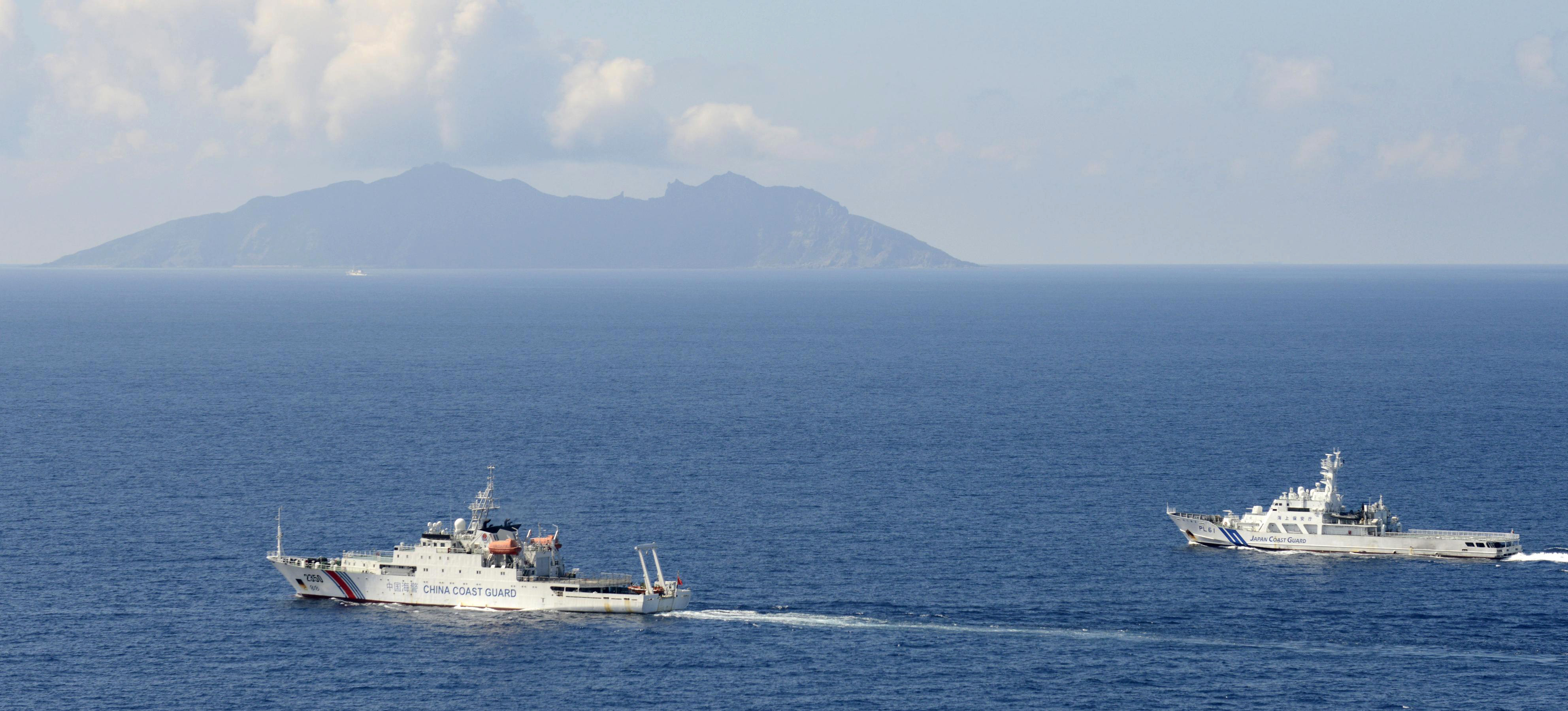 A China coast guard vessel, left, is followed by a Japan coast guard ship near the disputed East China Sea islands. Photo: AP