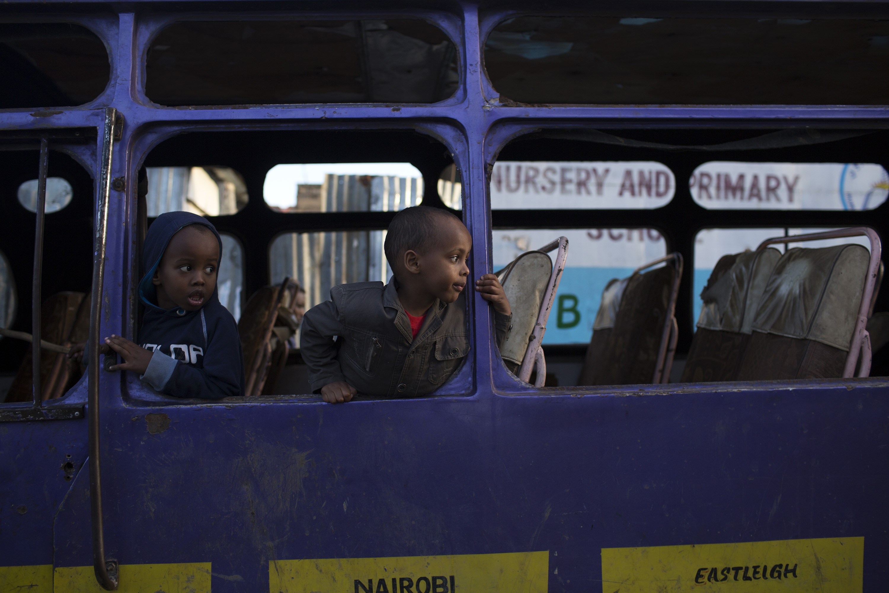 Children play in a broken down bus in Eastleigh, a suburb in Nairobi predominantly inhabited by Somali immigrants. Photo: Reuters