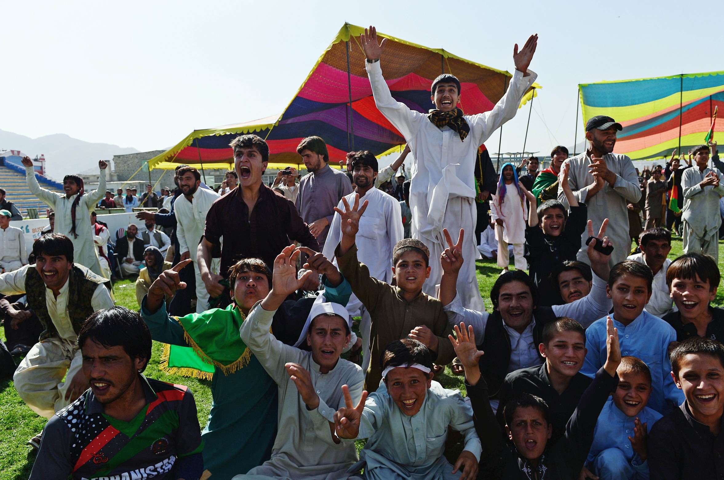 Afghan cricket fans celebrate runs by their team. Photo: AFP