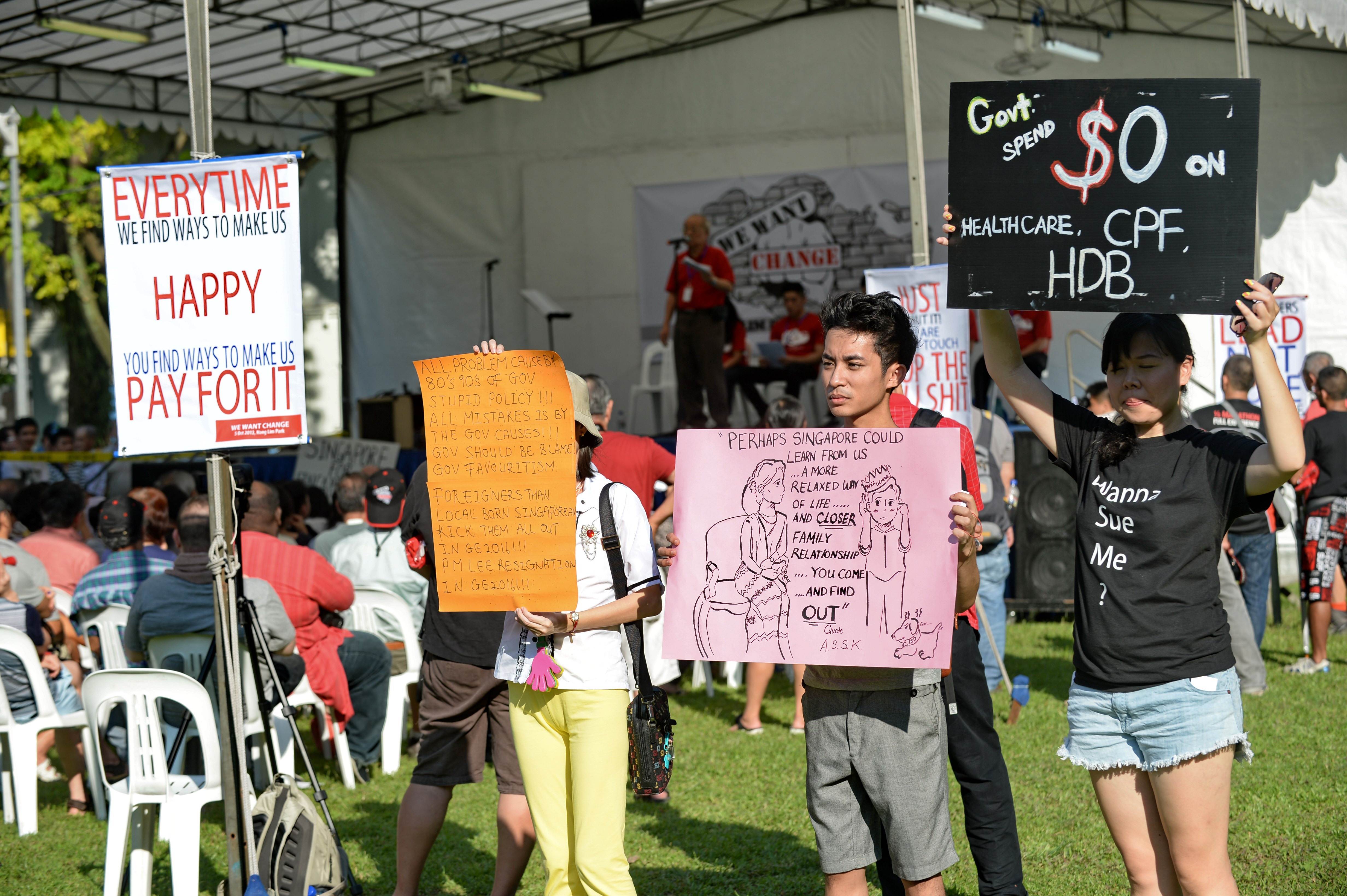 Protesters display placards during a rally at the speakers corner in Singapore on Saturday. Photo: AFP