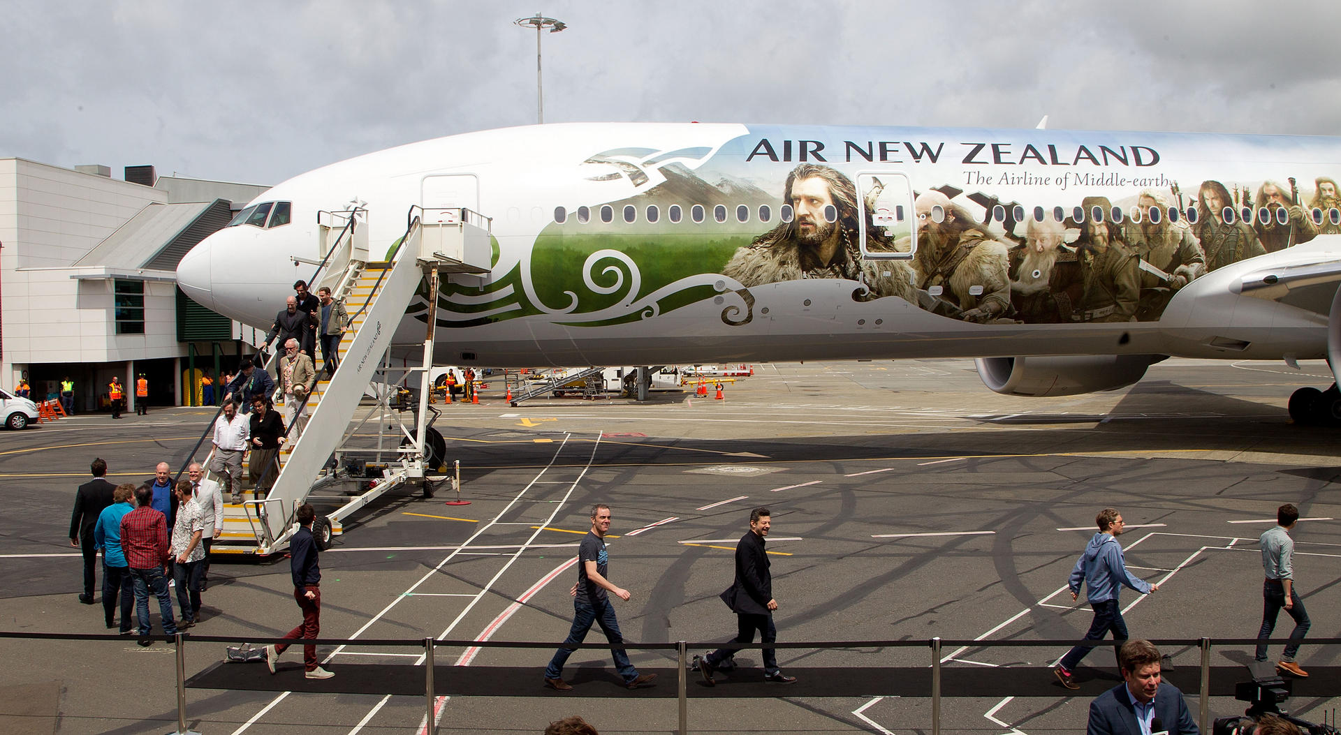 Crew and cast exit their plane, which was emblazoned with images of The Hobbit: An Unexpected Journey at Wellington Airport last year. Photo: AFP