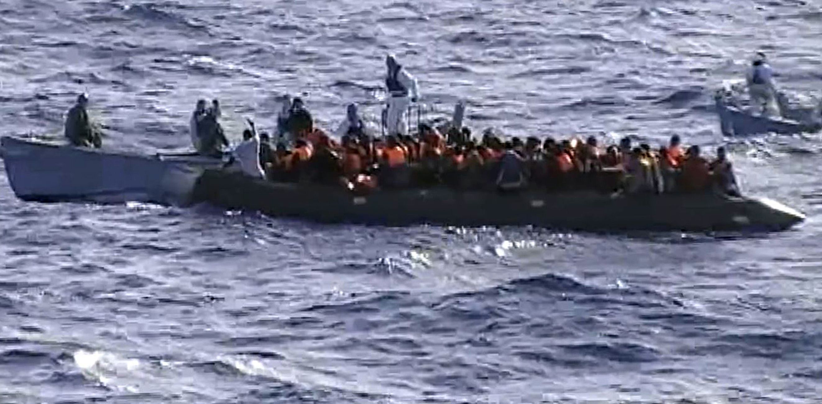 Immigrants aboard a raft while being rescued from the sea by Italian Navy off Lampedusa. Photo: AFP/Italian Navy