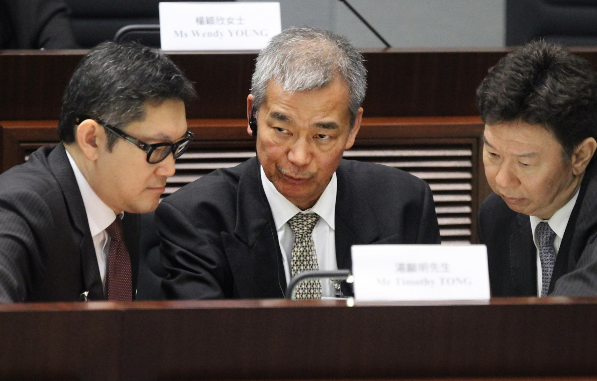 Lawyer Peter Wong (left) consults with Timothy Tong.