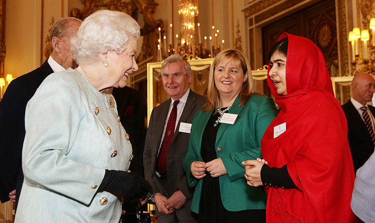 Queen Elizabeth II meets Malala Yousafzai during a reception at Buckingham Palace, London, Britain, on Friday. Photo: EPA