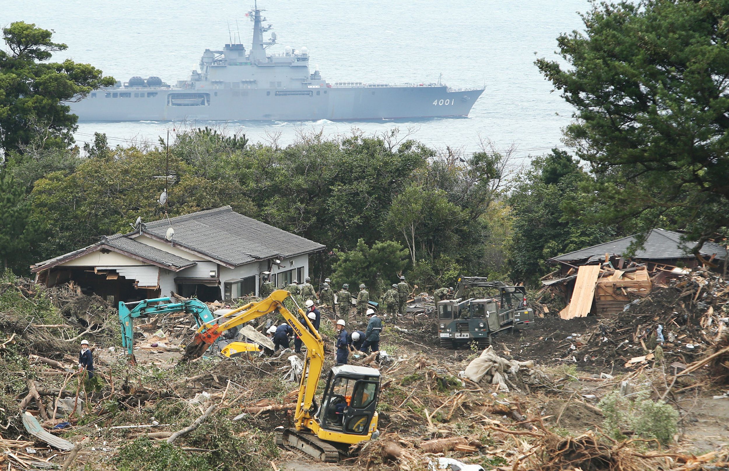 Soldiers remove debris from a damaged houses after a landslide at Oshima island. Photo: AFP
