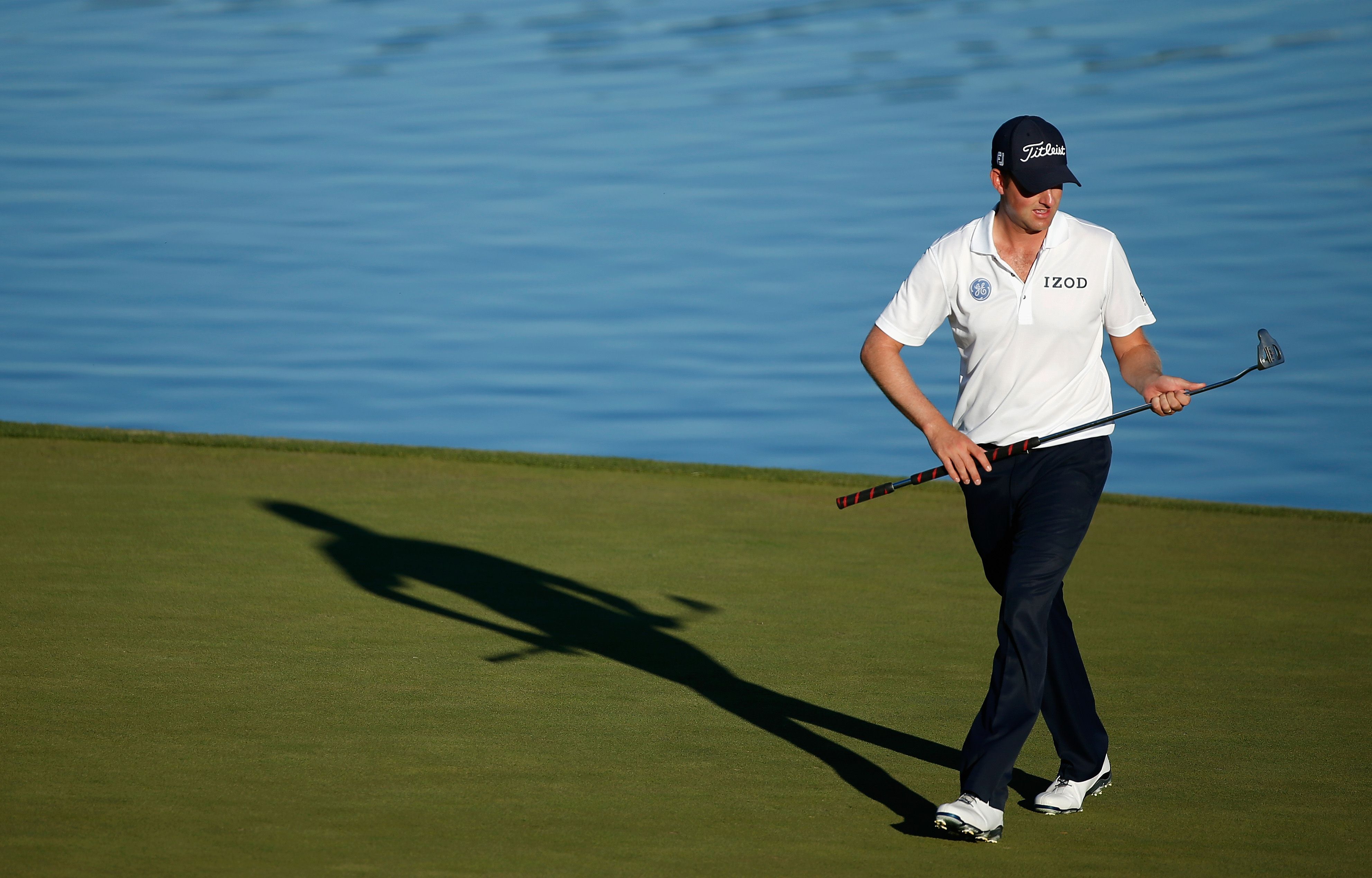 Webb Simpson examined his putter on the 16th green during the third round of the Shriners Hospitals for Children Open in Las Vegas. Photo: AFP